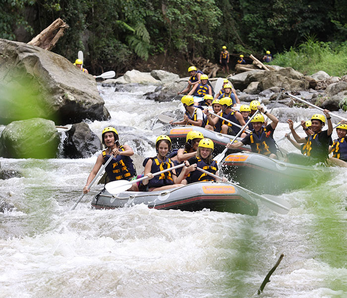 Adventurous approach through rocky canyon leading to hidden waterfall