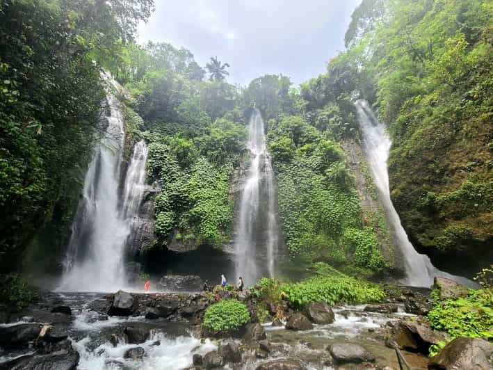 Natural pool at base of waterfall with clear turquoise water