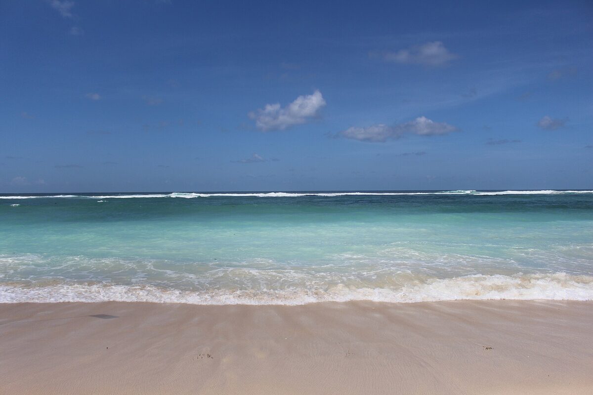 Sandy shoreline and turquoise water at Pandawa Beach in South Bali