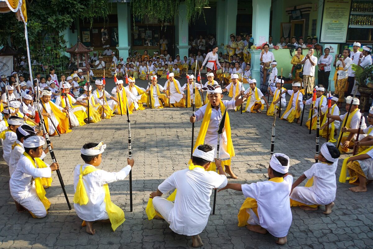 Students performing Tari Baris during a Saraswati Day celebration in Bali