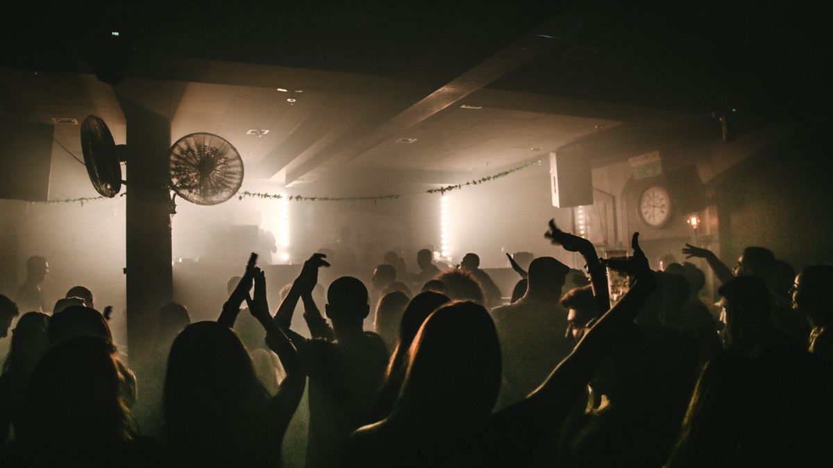 People on a dance floor in a dimly lit nightclub